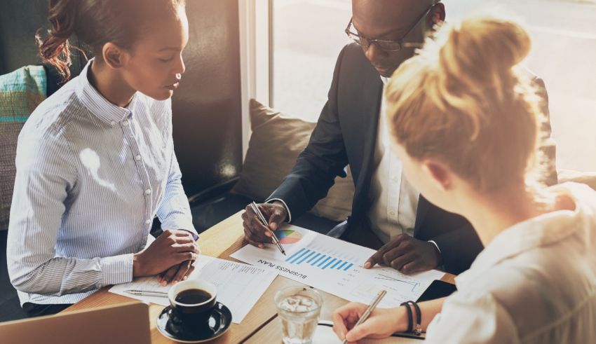 A group of business people sitting around a table.