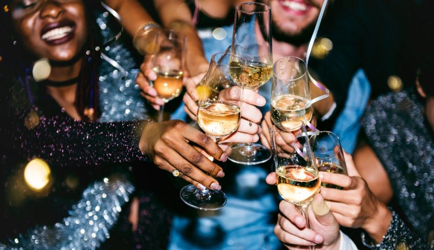 A group of people toasting champagne glasses at a party.