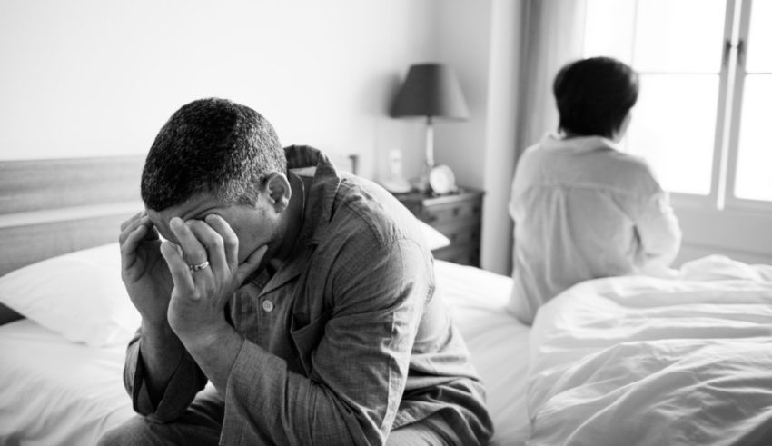 Black and white photo of a man and woman in bed.