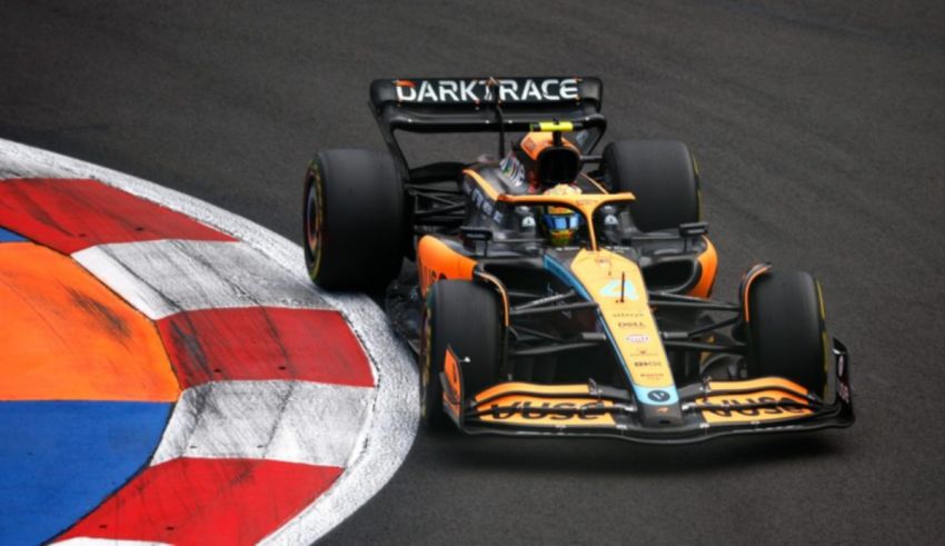 A black and orange racing car on a track.