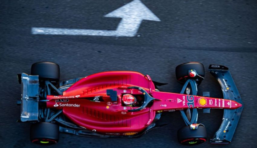 A red ferrari racing car on a track.
