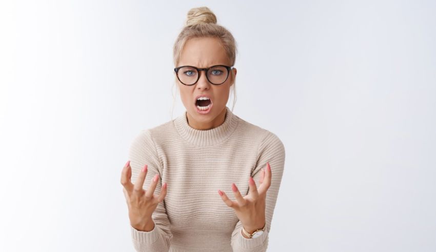 A woman in glasses is screaming on a white background.