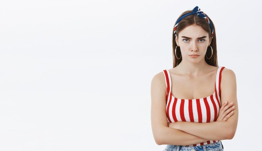 A young woman wearing a red, white and blue striped top and jeans.