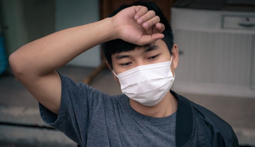 A young man wearing a surgical mask.