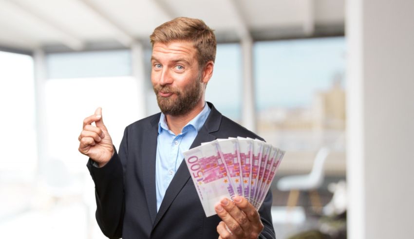 A man in a suit is holding a lot of money.