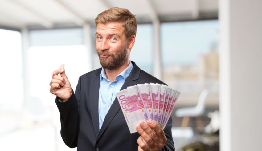 A businessman holding euro banknotes in his hand.