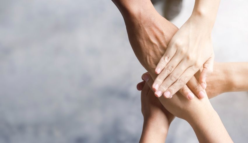 A group of people putting their hands together.