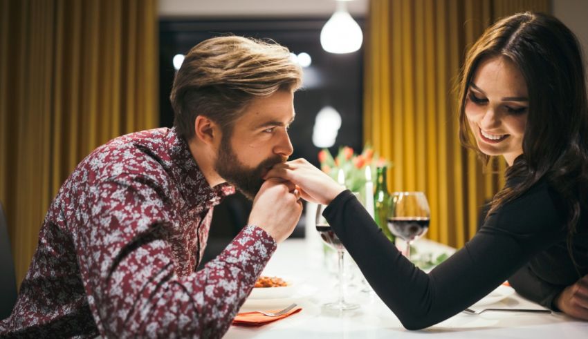 A man and woman are having dinner at a restaurant.