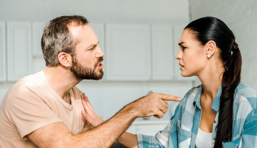 A man and woman arguing in the kitchen.
