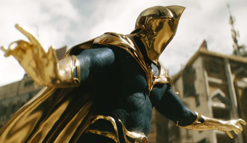 A man in a gold costume is standing in front of a city.
