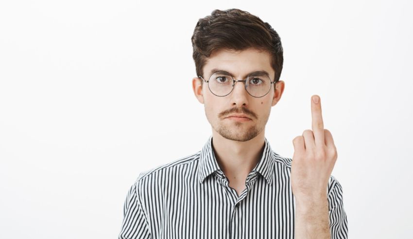 A man with glasses is pointing his finger at the camera.