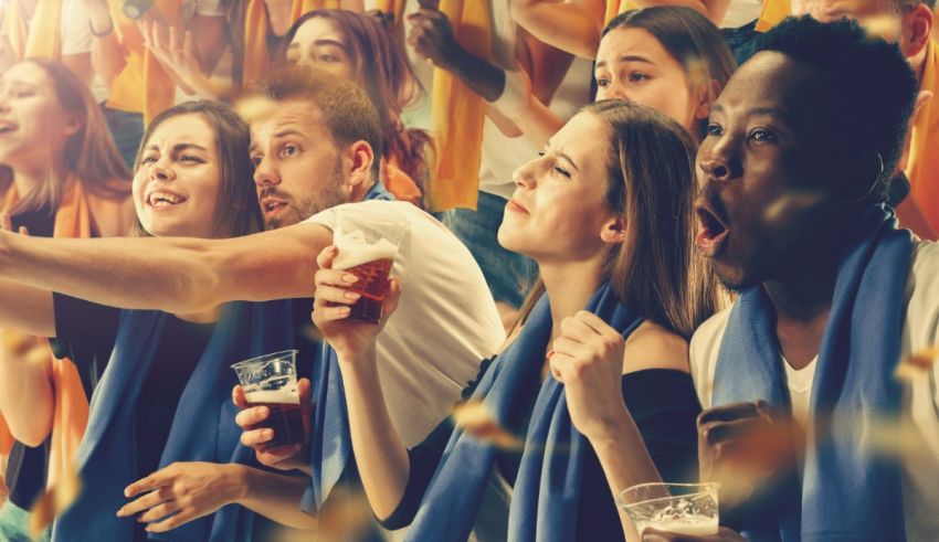 A group of people cheering at a soccer game.