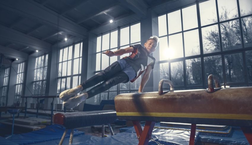 A woman is doing gymnastics on a beam in an indoor gym.