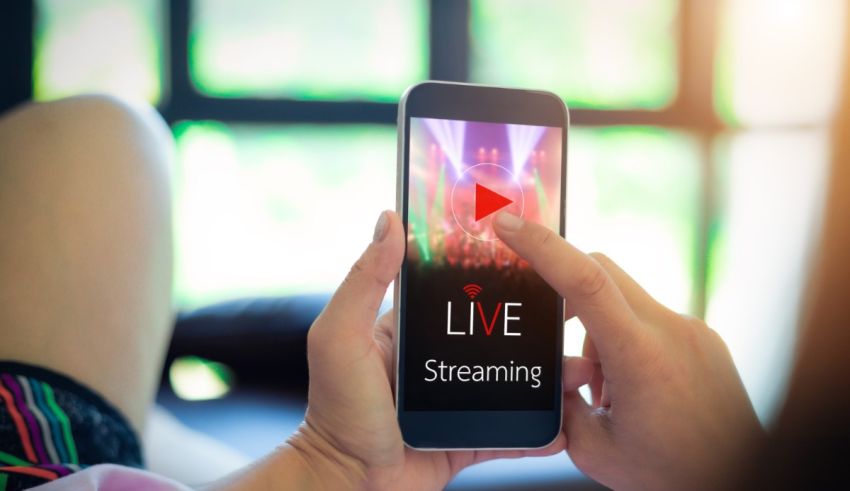 A woman is using a smart phone to watch a live stream.