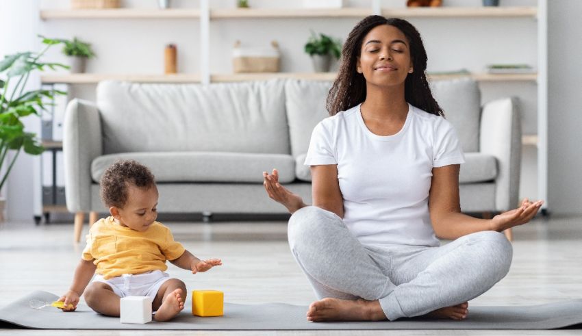 A woman meditating with her baby in the living room.