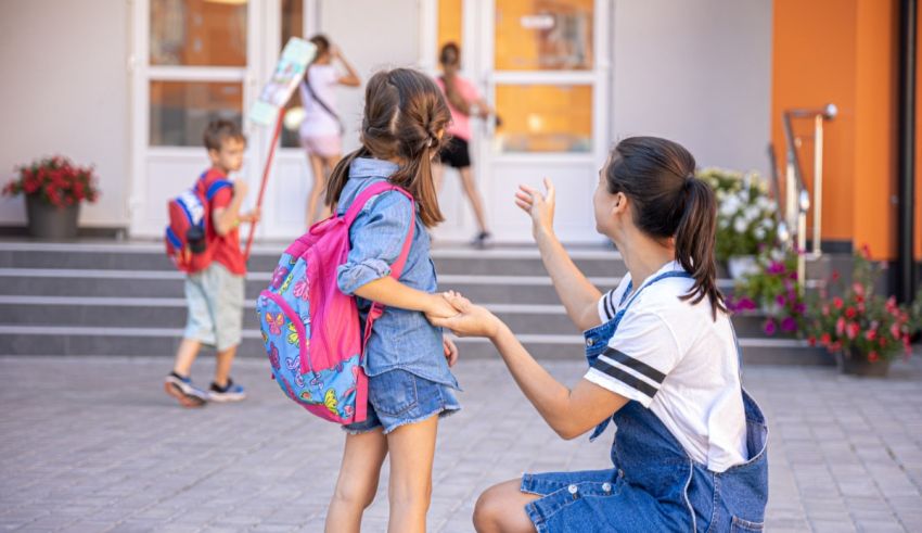 A woman is helping a little girl with her backpack.