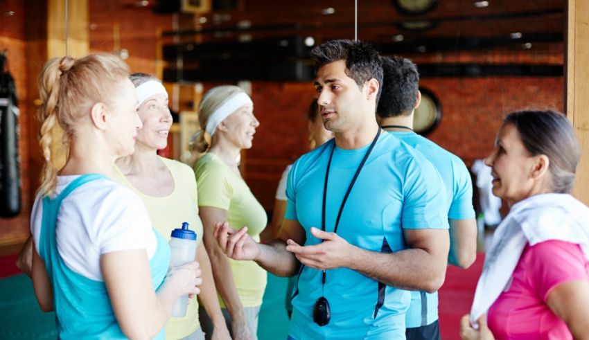 A group of people talking in a gym.