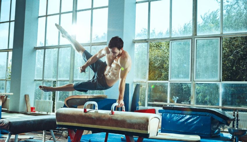 A man is doing a gymnastics routine in a gym.