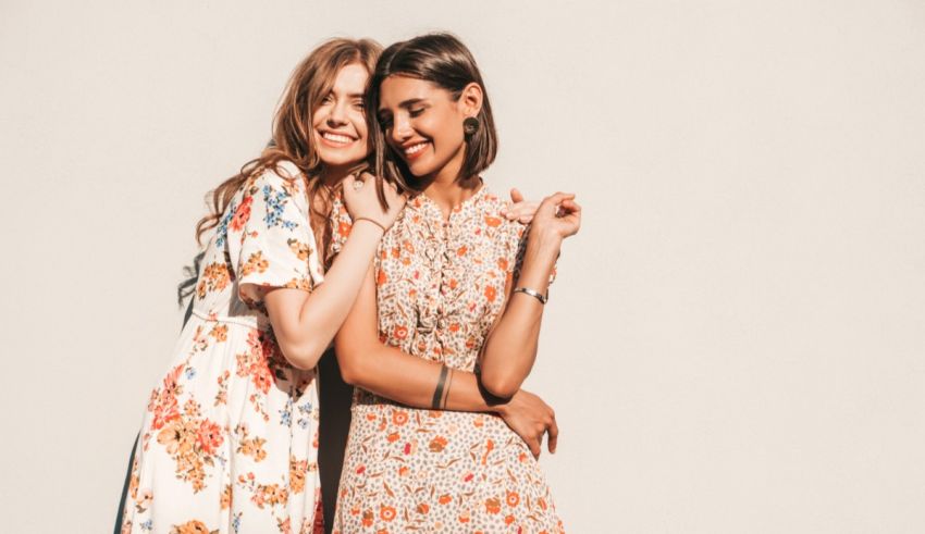 Two women in floral dresses posing for a photo.