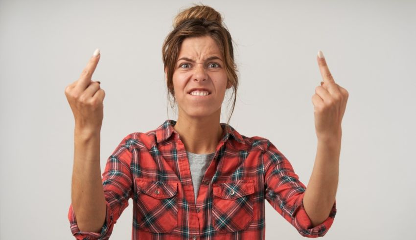 A woman with two fingers pointing at the camera.