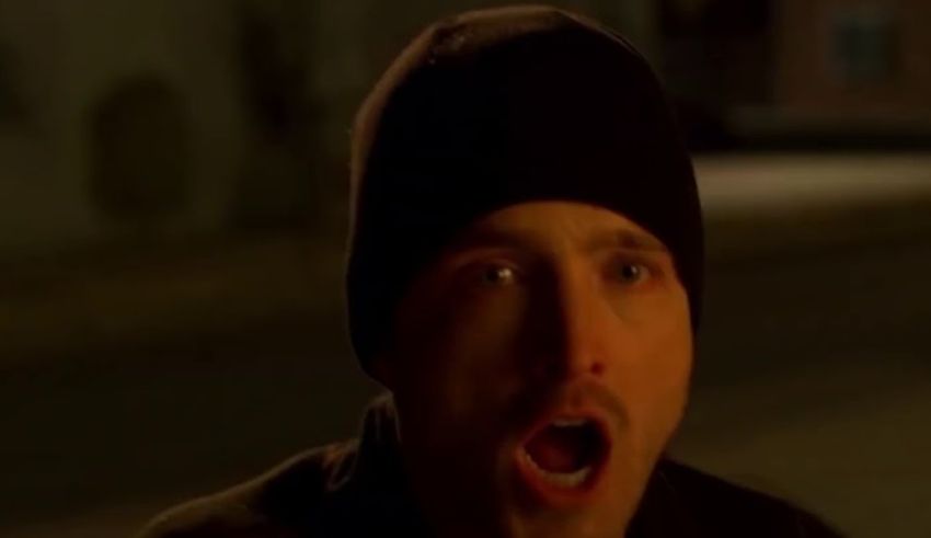 A man in a black beanie with his mouth open.