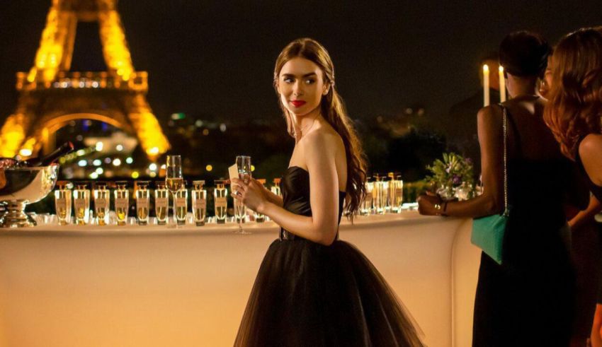 A woman in a black dress standing in front of the eiffel tower.