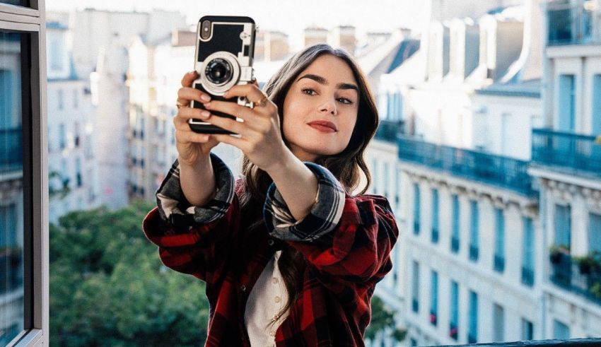 A woman is taking a selfie on a balcony in paris.