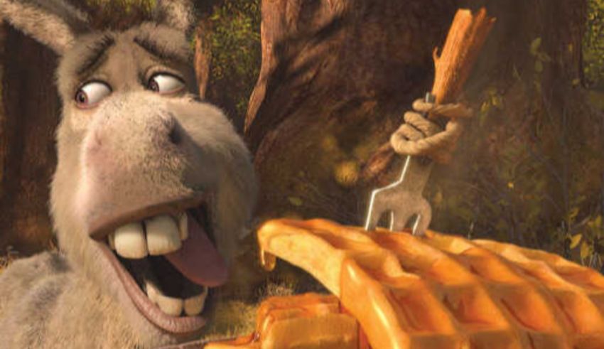 A donkey is eating a waffle in a forest.