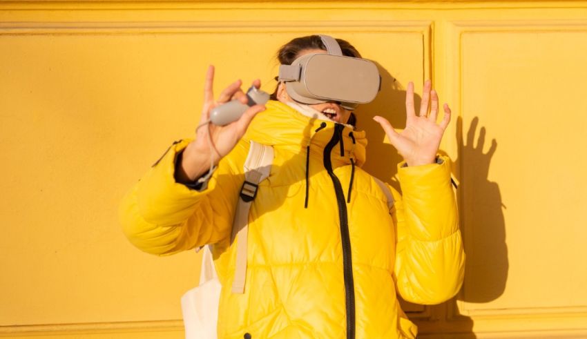 A woman in a yellow jacket is wearing a virtual reality headset.