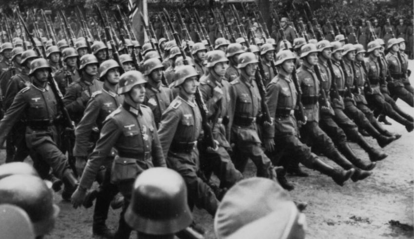 An old black and white photo of soldiers marching.