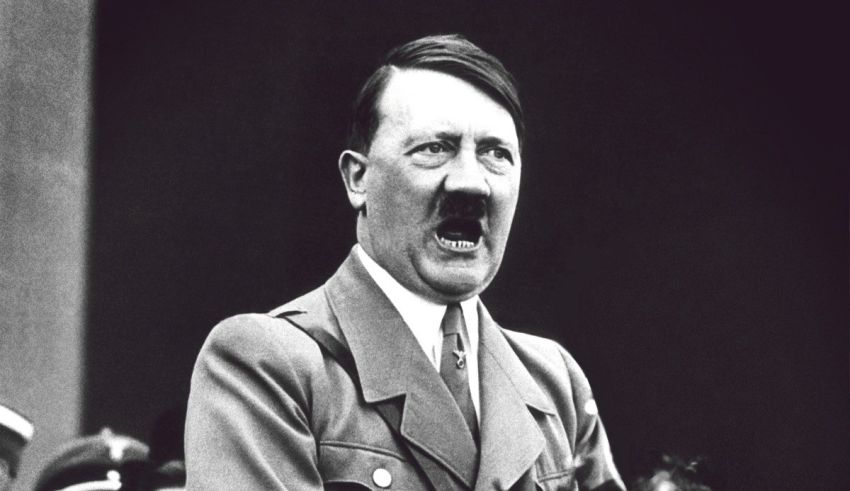 A black and white photo of hitler giving a speech.