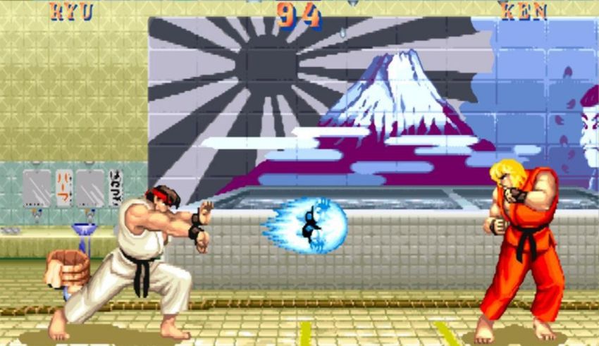 A street fighter game with two fighters fighting in front of a wall.