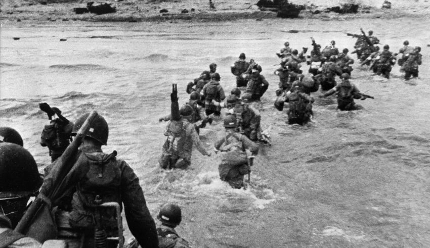 A group of soldiers walking through the water.