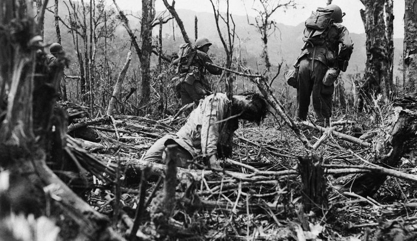 A group of soldiers in a wooded area.