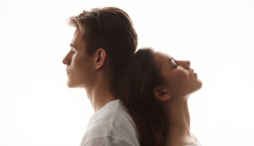 A silhouette of a man and woman looking at each other.