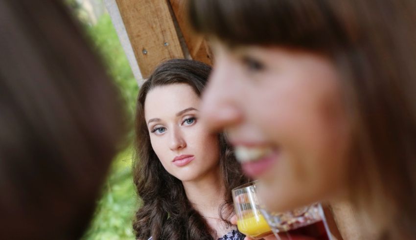 A group of women looking at each other at a restaurant.