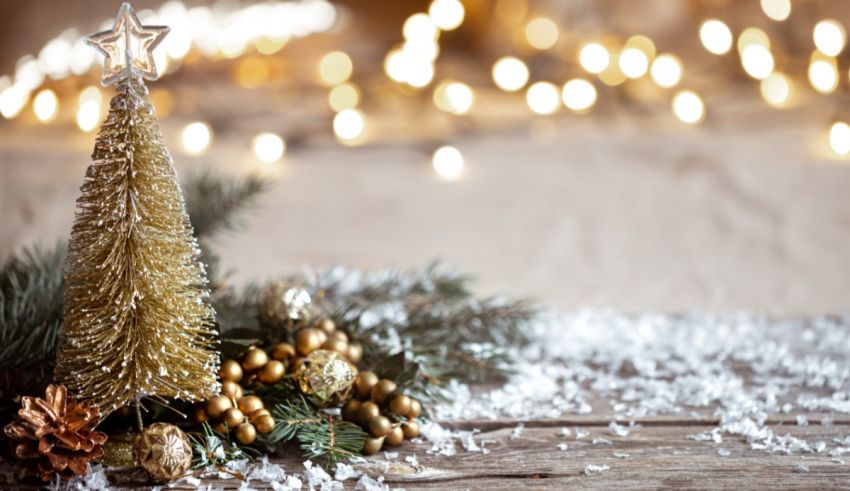 A golden christmas tree on a wooden table.