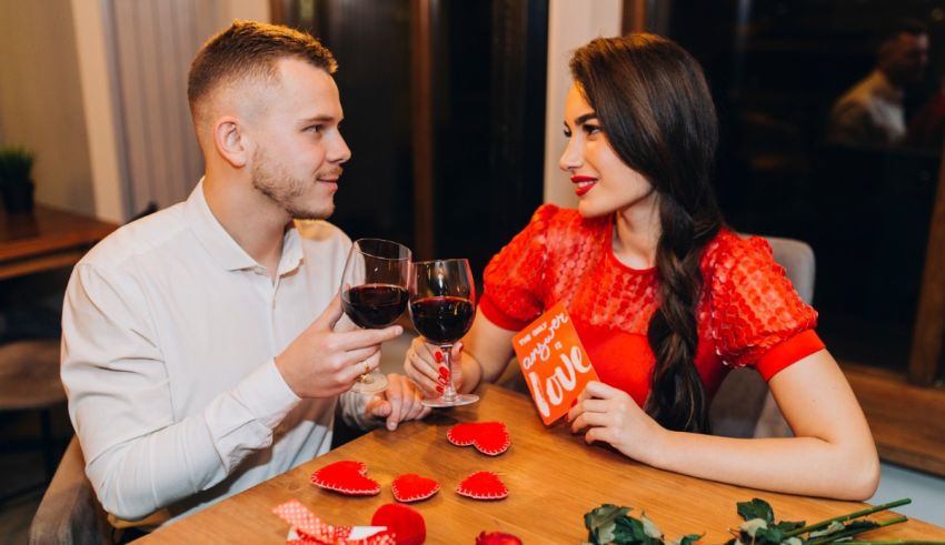 A man and a woman drinking wine at a restaurant.