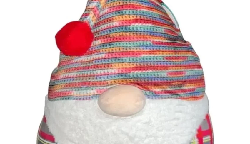 A stuffed gnome wearing a colorful hat.