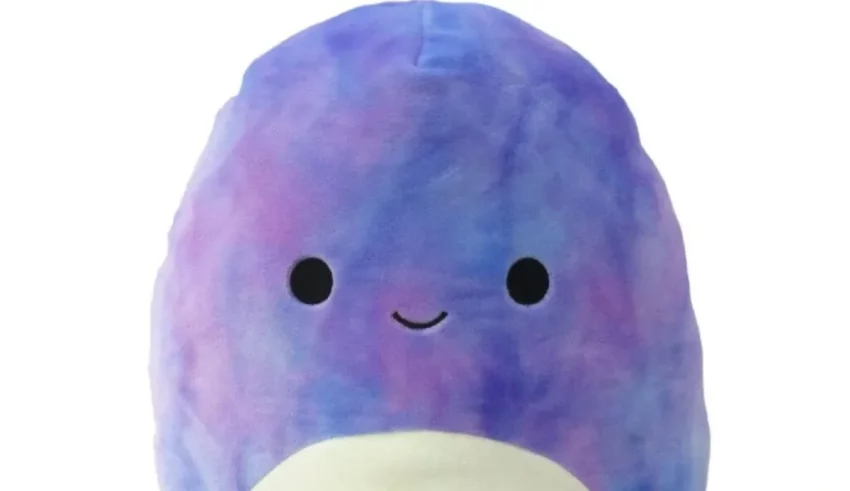 A blue and purple stuffed animal with a smile on its face.