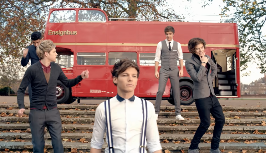 One direction in london on a double decker bus.