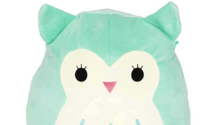 An owl shaped plush toy on a white background.