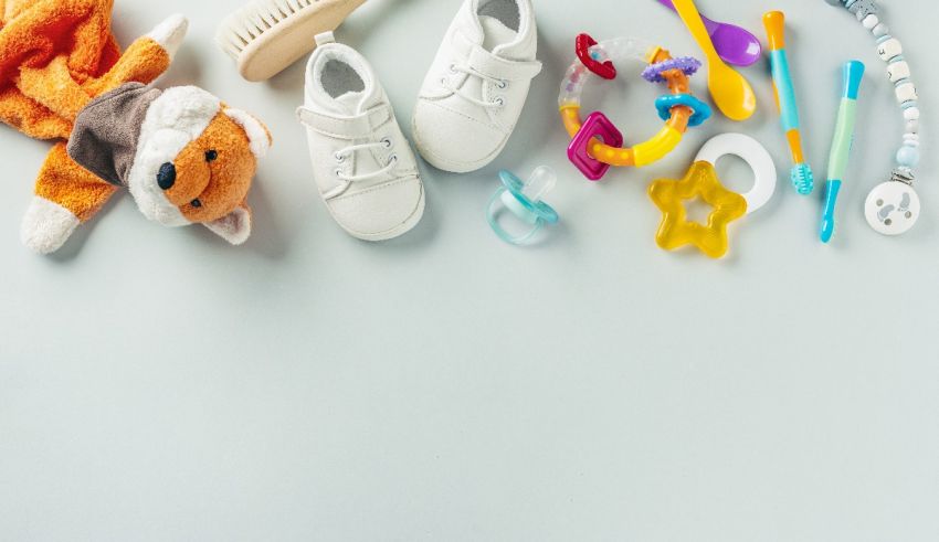 A group of baby items arranged on a gray background.