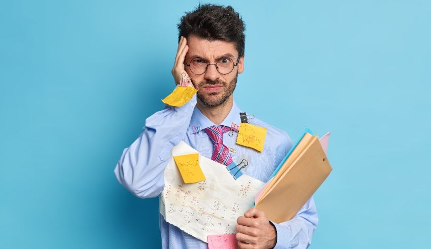A businessman holding a folder with sticky notes on his head.