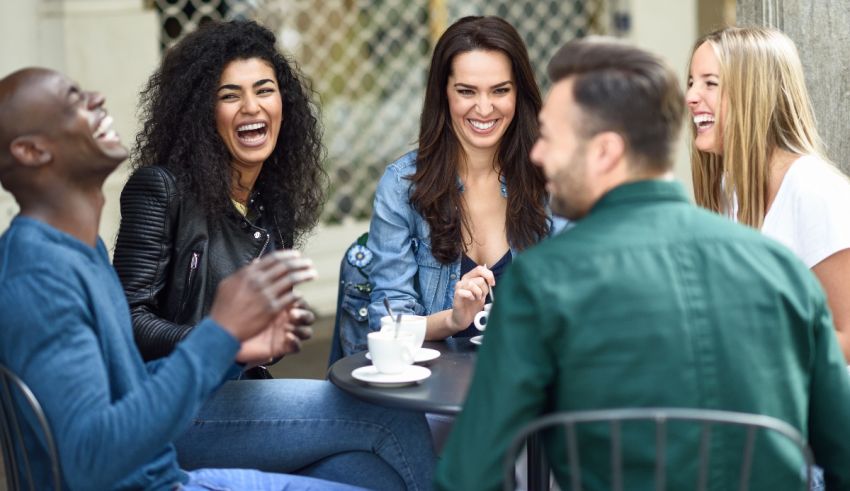 A group of friends laughing at a coffee shop.