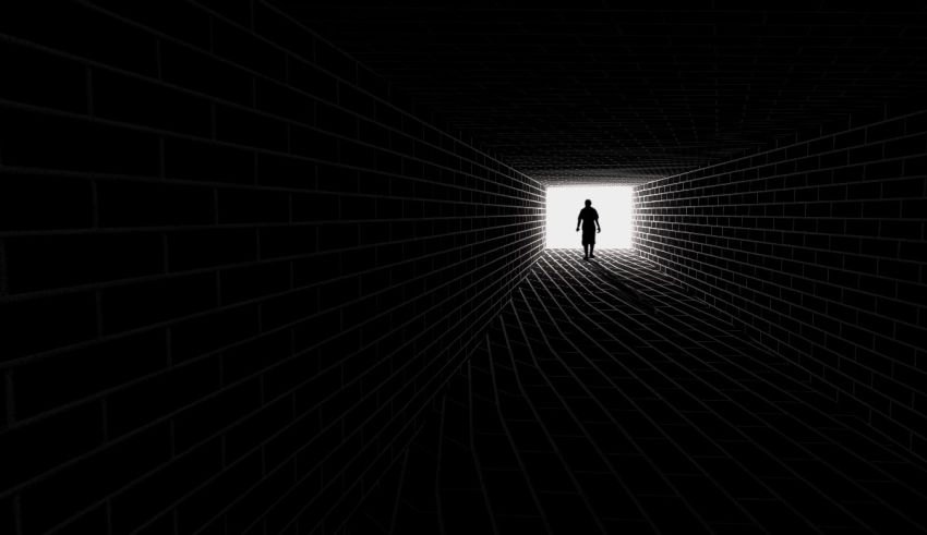 An image of a person standing in a dark tunnel.