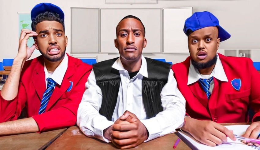 Three men in school uniforms sitting at a desk.