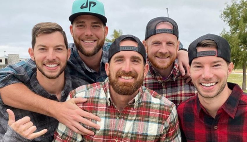 A group of men in plaid hats posing for a picture.