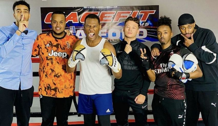 A group of men posing for a picture in a boxing ring.