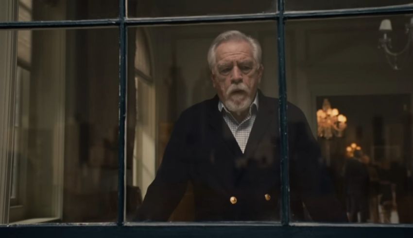 An older man looking out of a window.